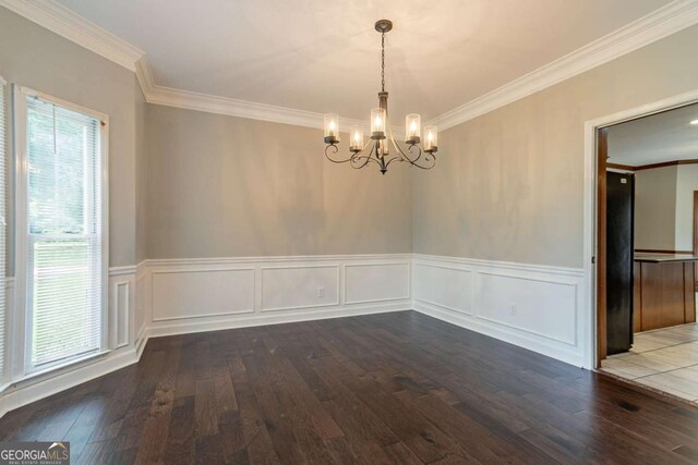 214 Jamestown Ave, Jonesboro, GA 30236 - unfurnished dining area featuring hardwood / wood-style flooring, crown molding, a chandelier, and wainscoting