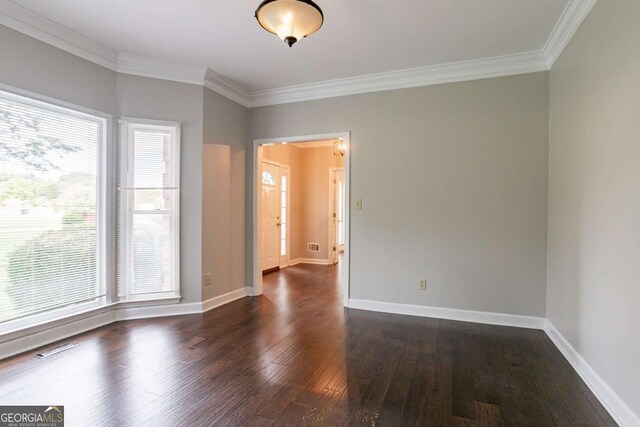 214 Jamestown Ave, Jonesboro, GA 30236 - spare room featuring healthy amount of natural light, crown molding, and dark wood-type flooring