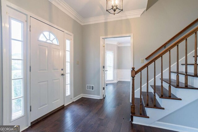 214 Jamestown Ave, Jonesboro, GA 30236 - entryway featuring crown molding, dark wood finished floors, plenty of natural light, stairs, and a chandelier