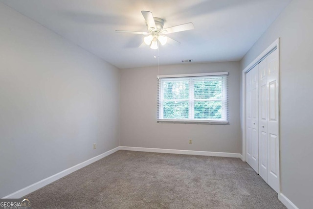 214 Jamestown Ave, Jonesboro, GA 30236 - unfurnished bedroom featuring carpet, a closet, and ceiling fan