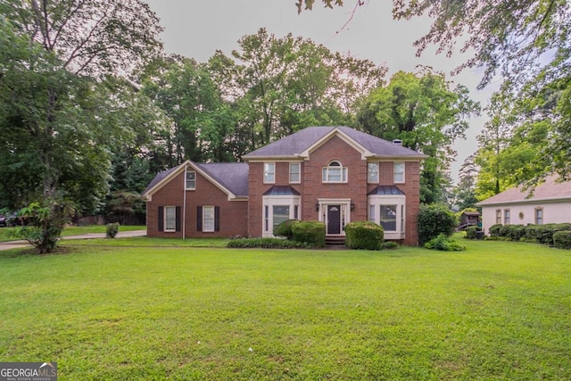 214 Jamestown Ave, Jonesboro, GA 30236 - colonial-style house with brick siding and a front yard