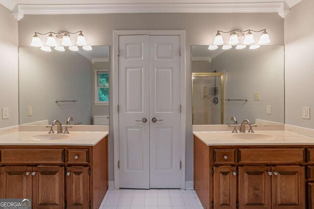 214 Jamestown Ave, Jonesboro, GA 30236 - bathroom featuring ornamental molding, two vanities, a shower stall, tile patterned flooring, and a closet