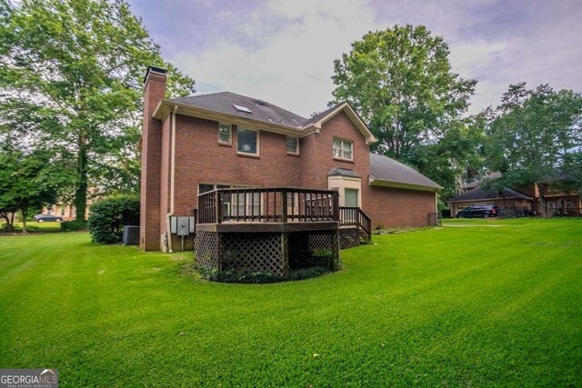 214 Jamestown Ave, Jonesboro, GA 30236 - rear view of property featuring a chimney, a wooden deck, a lawn, and brick siding