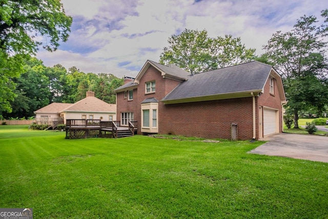 214 Jamestown Ave, Jonesboro, GA 30236 - rear view of house with brick siding, a wooden deck, a yard, a garage, and driveway