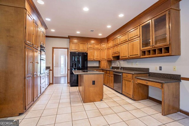 214 Jamestown Ave, Jonesboro, GA 30236 - kitchen featuring appliances with stainless steel finishes, brown cabinetry, a center island, recessed lighting, and light tile patterned flooring