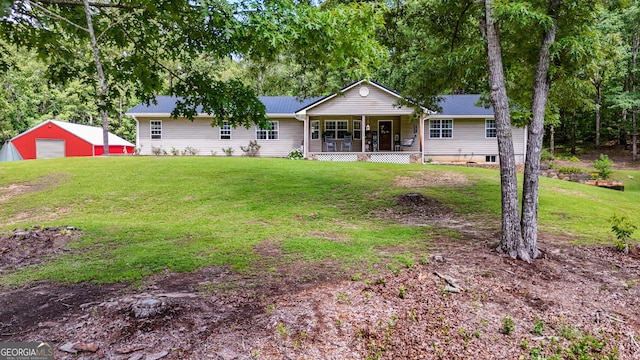 75 Barber Rd, Carrollton, GA 30116 - rear view of property featuring covered porch, a yard, metal roof, an outdoor structure, and a detached garage