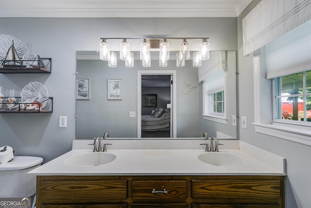 75 Barber Rd, Carrollton, GA 30116 - bathroom with double vanity, ensuite bathroom, plenty of natural light, toilet, and crown molding