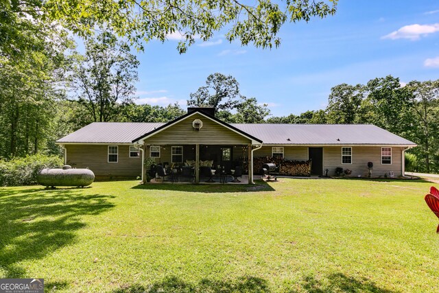 75 Barber Rd, Carrollton, GA 30116 - rear view of house with a yard, a patio, metal roof, and a chimney