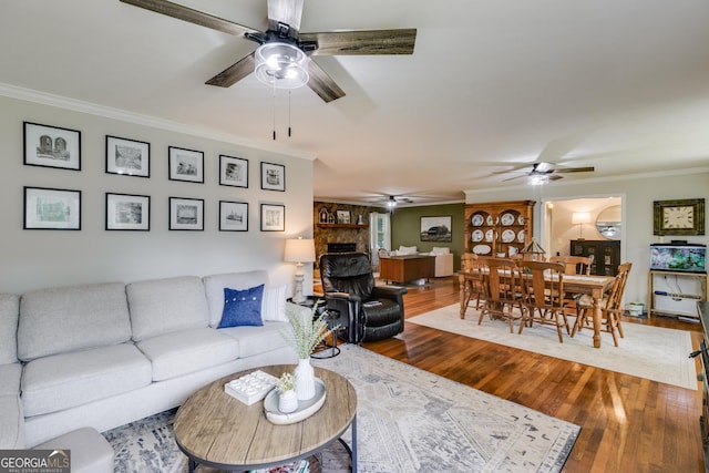 75 Barber Rd, Carrollton, GA 30116 - living room featuring a ceiling fan, ornamental molding, a fireplace, and wood finished floors