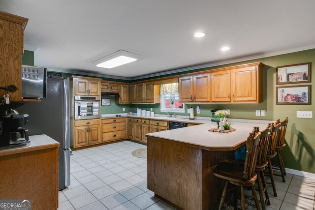 75 Barber Rd, Carrollton, GA 30116 - kitchen with appliances with stainless steel finishes, a peninsula, light tile patterned floors, crown molding, and light countertops