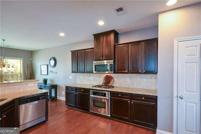 1480 Waverly Glen Dr, Alpharetta, GA 30004 - kitchen featuring stainless steel appliances, dark wood finished floors, dark brown cabinets, tasteful backsplash, and recessed lighting