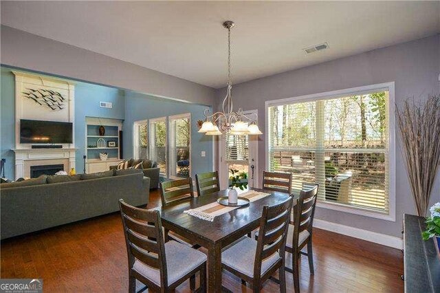 1480 Waverly Glen Dr, Alpharetta, GA 30004 - dining space with a chandelier, wood finished floors, and a fireplace