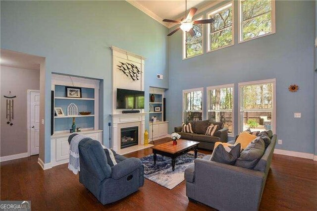 1480 Waverly Glen Dr, Alpharetta, GA 30004 - living area with a high ceiling, ceiling fan, dark wood finished floors, plenty of natural light, and crown molding