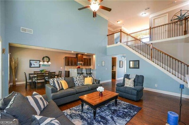 1480 Waverly Glen Dr, Alpharetta, GA 30004 - living room with a high ceiling, a ceiling fan, stairway, wood finished floors, and crown molding