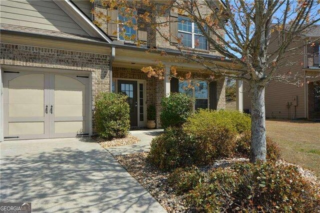 1480 Waverly Glen Dr, Alpharetta, GA 30004 - doorway to property with a garage, driveway, and brick siding