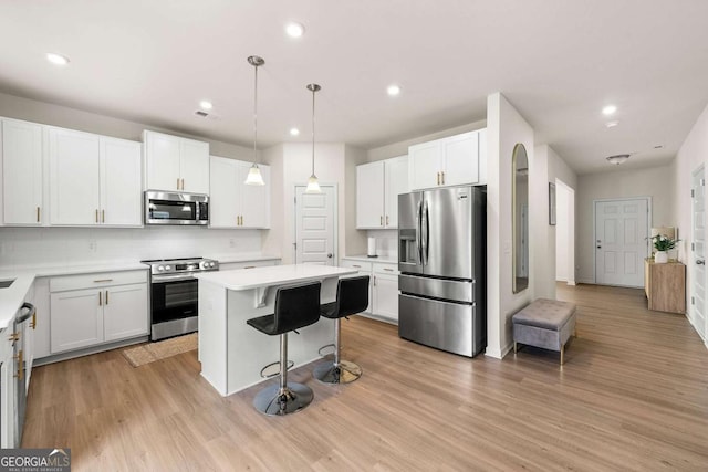 228 Whitneys Way, Dallas, GA 30157 - kitchen featuring appliances with stainless steel finishes, a breakfast bar area, a center island, light countertops, and recessed lighting
