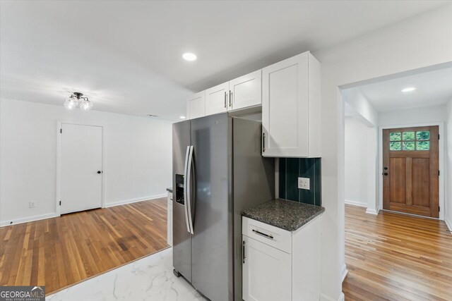 2310 Toussaint Ave, Savannah, GA 31404 - kitchen with stainless steel refrigerator with ice dispenser, white cabinets, light wood-style flooring, recessed lighting, and dark stone countertops