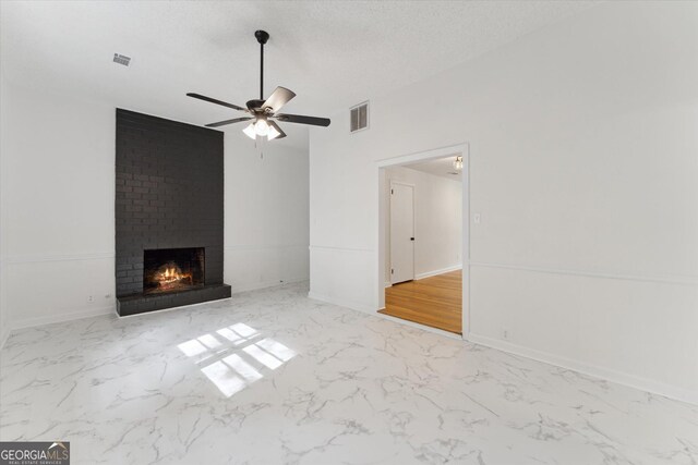 2310 Toussaint Ave, Savannah, GA 31404 - unfurnished living room featuring marble finish flooring, a brick fireplace, and a ceiling fan