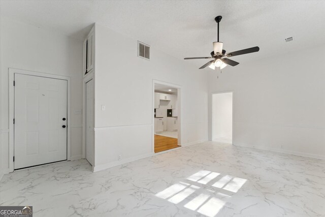2310 Toussaint Ave, Savannah, GA 31404 - empty room featuring ceiling fan and marble look tiles