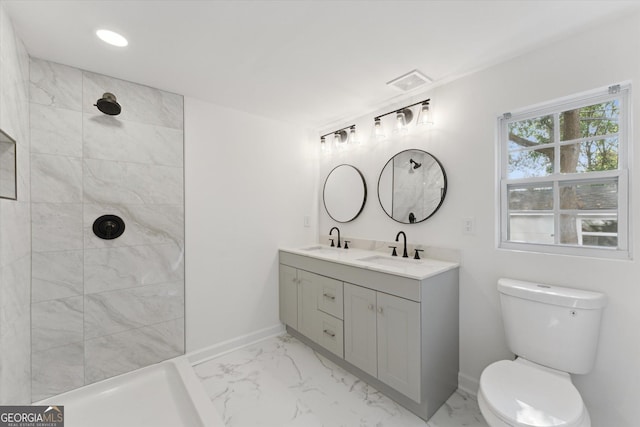 2310 Toussaint Ave, Savannah, GA 31404 - bathroom featuring marble look tiles, double vanity, tiled shower, and recessed lighting