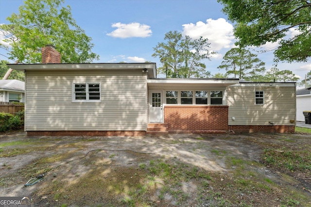2310 Toussaint Ave, Savannah, GA 31404 - rear view of property featuring entry steps and a chimney