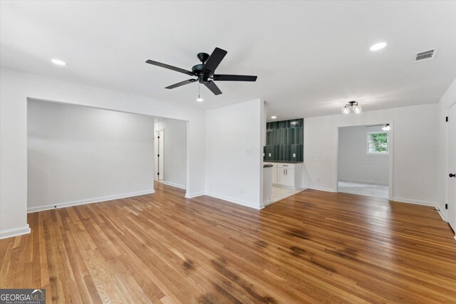 2310 Toussaint Ave, Savannah, GA 31404 - unfurnished living room with light wood finished floors, ceiling fan, and recessed lighting
