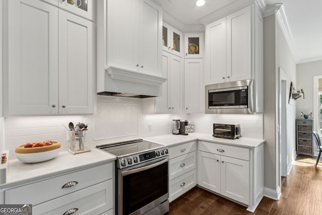 109 Carrington Ct, Kingsland, GA 31548 - kitchen with stainless steel appliances, ornamental molding, light countertops, white cabinets, and glass insert cabinets