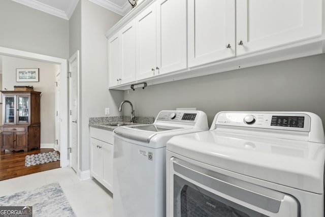 109 Carrington Ct, Kingsland, GA 31548 - washroom featuring ornamental molding, washing machine and dryer, cabinet space, and light tile patterned floors