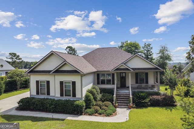 109 Carrington Ct, Kingsland, GA 31548 - view of front of property with covered porch, a front yard, and roof with shingles