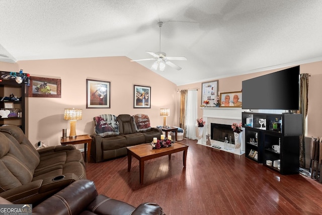 8436 Cyprus Ridge Way, Douglasville, GA 30134 - living area with a ceiling fan, vaulted ceiling, a fireplace, hardwood / wood-style floors, and a textured ceiling