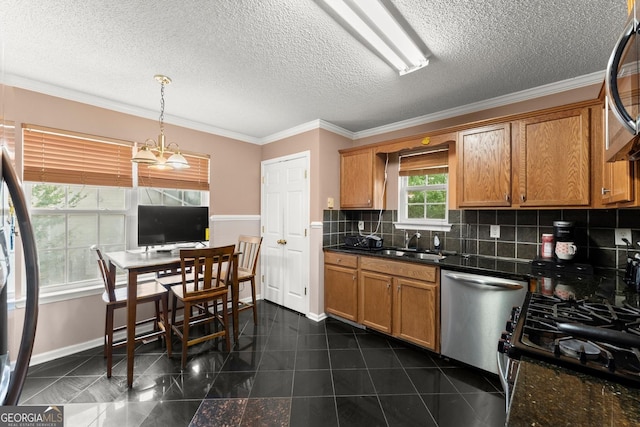 8436 Cyprus Ridge Way, Douglasville, GA 30134 - kitchen with appliances with stainless steel finishes, a sink, dark countertops, tasteful backsplash, and ornamental molding