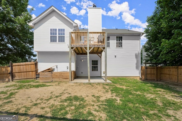 8436 Cyprus Ridge Way, Douglasville, GA 30134 - back of property with a fenced backyard, a chimney, a patio area, a wooden deck, and a gate