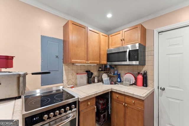 8436 Cyprus Ridge Way, Douglasville, GA 30134 - kitchen with stainless steel appliances, electric panel, decorative backsplash, light countertops, and ornamental molding