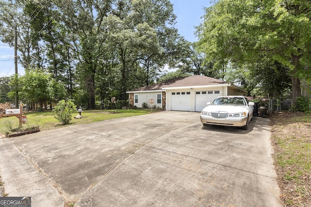 214 Highland Dr, Warner Robins, GA 31088 - view of front of home with concrete driveway, a front lawn, and an attached garage