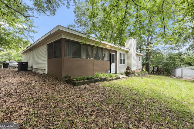 214 Highland Dr, Warner Robins, GA 31088 - rear view of property with cooling unit and a chimney