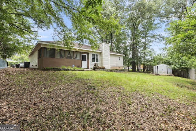 214 Highland Dr, Warner Robins, GA 31088 - back of property with a chimney and a sunroom