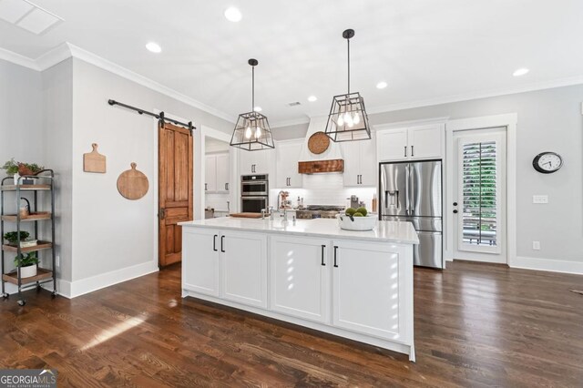221 Goss Ln, Ball Ground, GA 30107 - kitchen featuring stainless steel appliances, a barn door, white cabinetry, recessed lighting, and ornamental molding