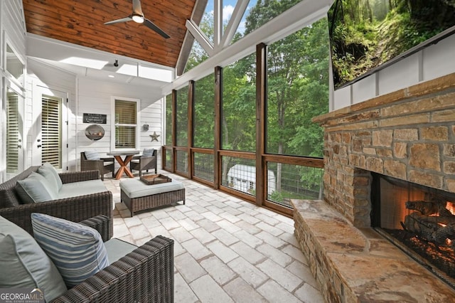 221 Goss Ln, Ball Ground, GA 30107 - sunroom / solarium with high vaulted ceiling, a ceiling fan, outdoor dining area, an outdoor living space with a fireplace, and plenty of natural light