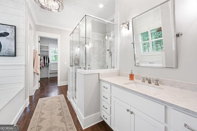 221 Goss Ln, Ball Ground, GA 30107 - bathroom with vanity, a walk in closet, a stall shower, crown molding, and wood finished floors