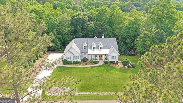 221 Goss Ln, Ball Ground, GA 30107 - view of front facade featuring a chimney, a front lawn, and a forest view