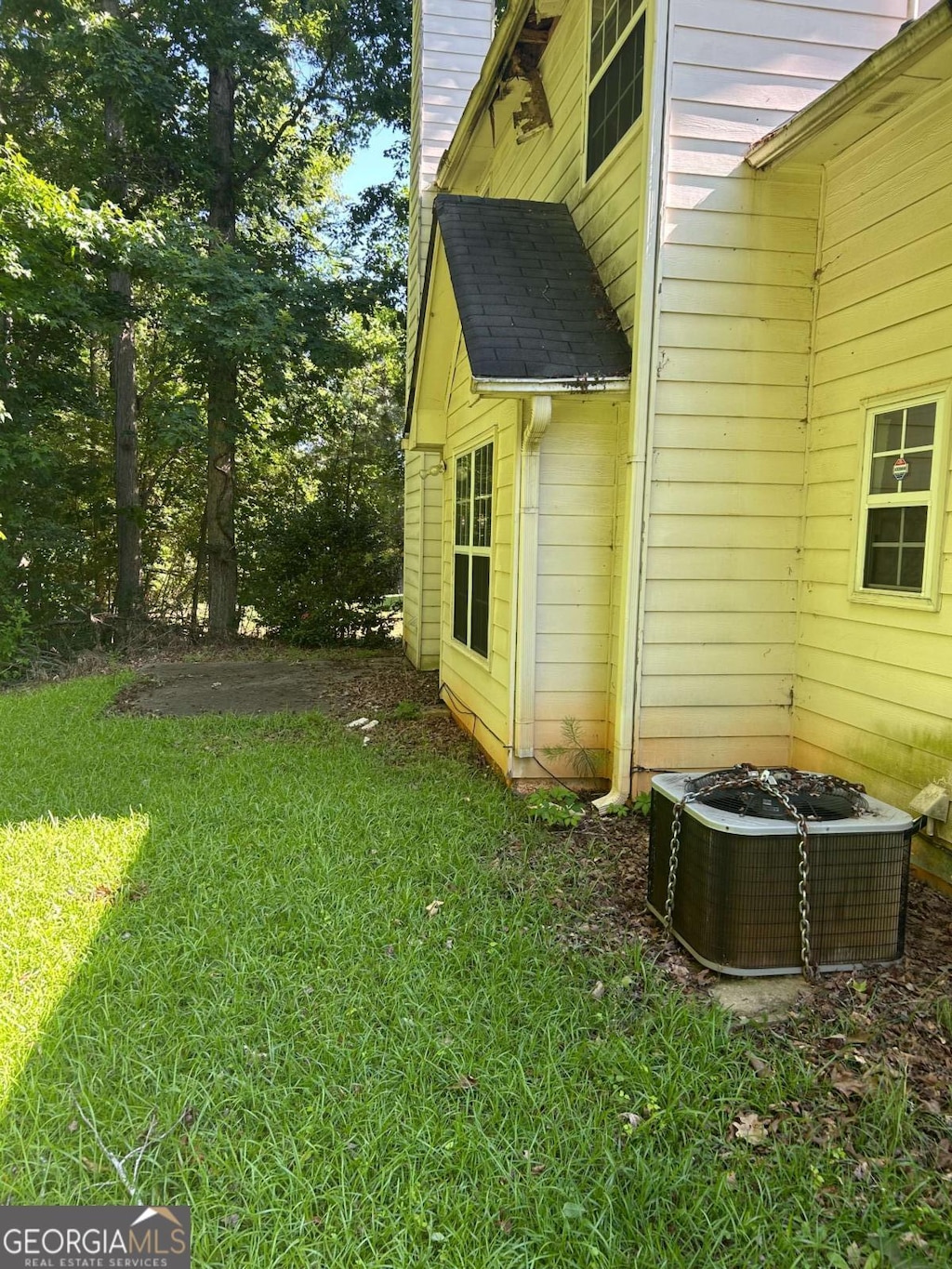 2581 Star Ln, Decatur, GA 30034 - view of property exterior featuring central air condition unit, a lawn, and a chimney