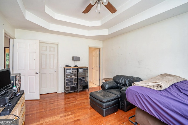 259 Hanover Cir SE, Calhoun, GA 30701 - bedroom featuring a tray ceiling, light wood finished floors, and a ceiling fan