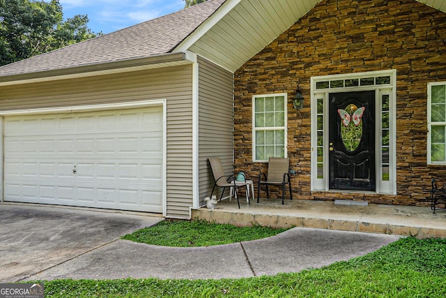 259 Hanover Cir SE, Calhoun, GA 30701 - doorway to property featuring stone siding, roof with shingles, concrete driveway, and a garage