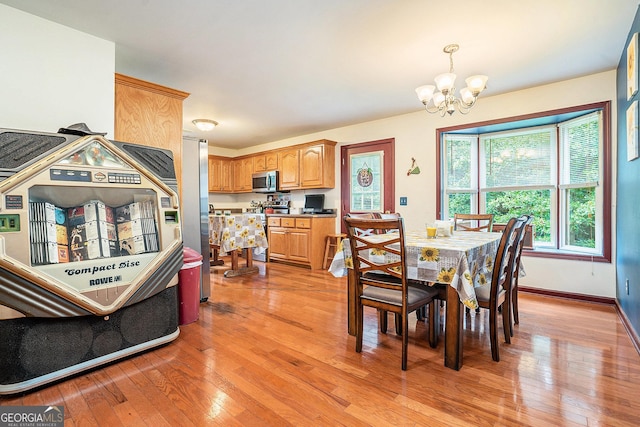 259 Hanover Cir SE, Calhoun, GA 30701 - dining area with a chandelier and light wood-style floors
