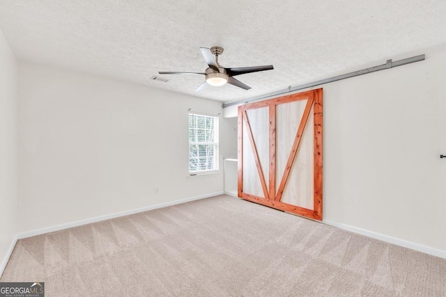 1186 Hawthorn Ln, Grayson, GA 30017 - unfurnished room featuring light carpet, a ceiling fan, and a textured ceiling