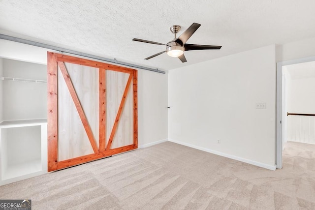 1186 Hawthorn Ln, Grayson, GA 30017 - unfurnished bedroom with carpet floors, ceiling fan, and a textured ceiling