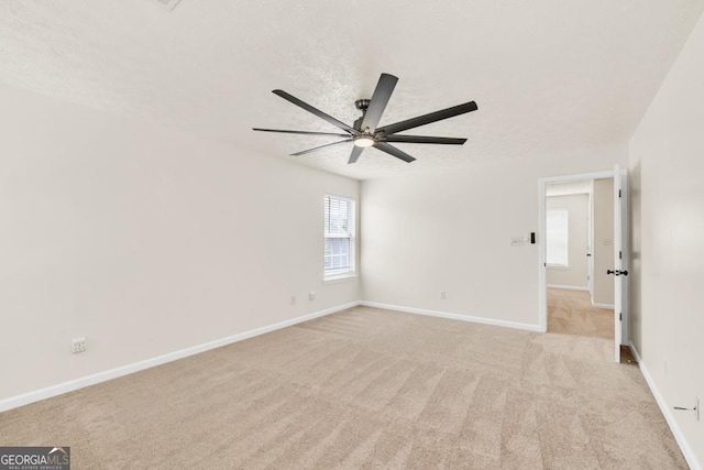 1186 Hawthorn Ln, Grayson, GA 30017 - spare room featuring a ceiling fan, light colored carpet, and a textured ceiling