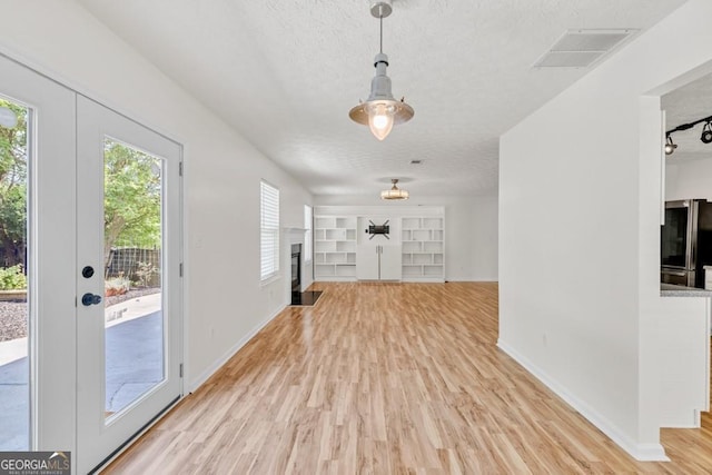 1186 Hawthorn Ln, Grayson, GA 30017 - entryway featuring plenty of natural light, light wood-style floors, and a textured ceiling