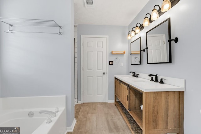 1186 Hawthorn Ln, Grayson, GA 30017 - bathroom featuring double vanity, a bath, and wood finished floors