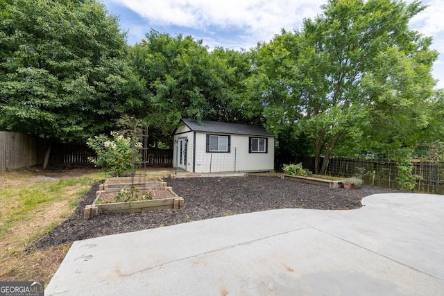 1186 Hawthorn Ln, Grayson, GA 30017 - view of outdoor structure featuring a vegetable garden and a fenced backyard